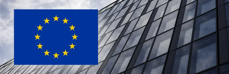 Company building with a prominent European Union flag, illustrating DORA compliance requirements and the use of Drvless to support compliance efforts.